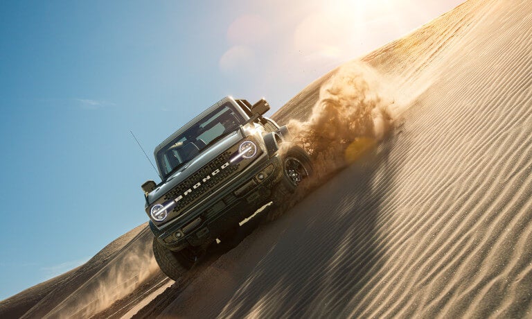 2023 Ford Bronco drifting through sand dunes