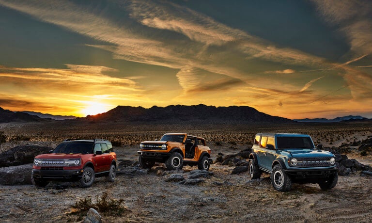 Three 2023 Ford Broncos parked in the desert