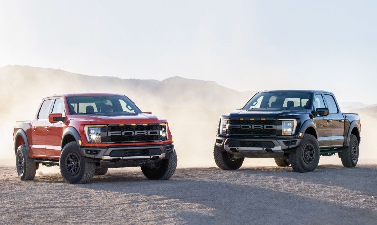 Two 2023 Ford F-150s parked in the desert