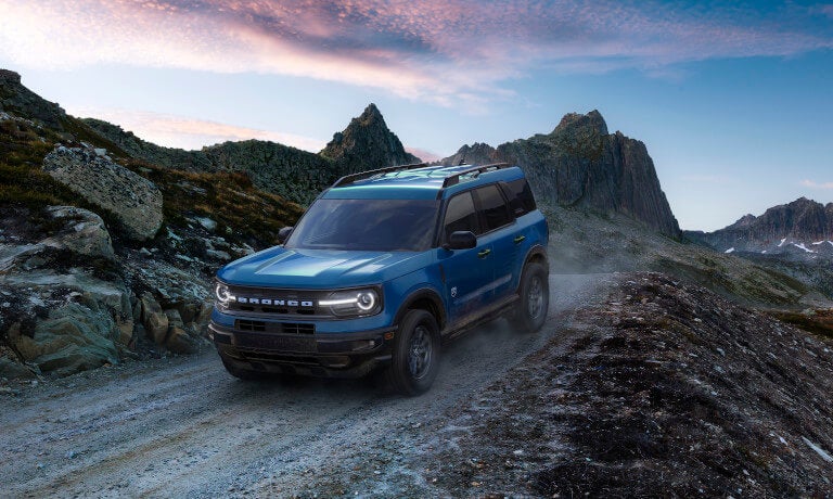 2026 Ford Bronco driving in mountains at sunrise