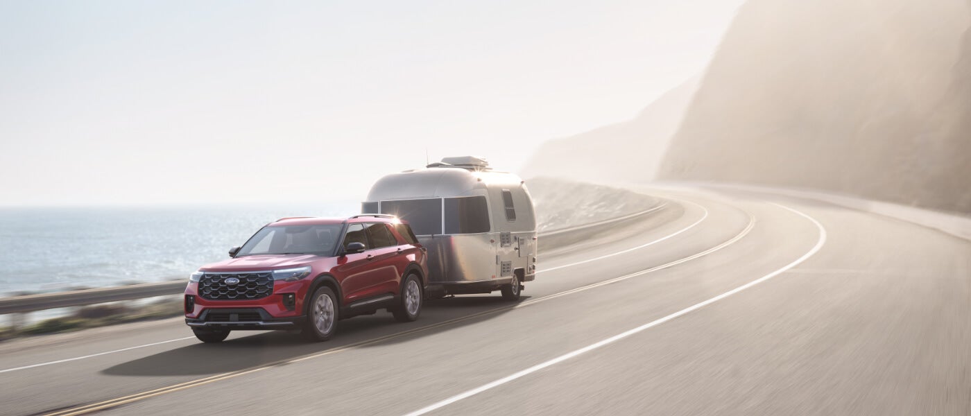 2026 Ford Explorer towing a camper on curve
