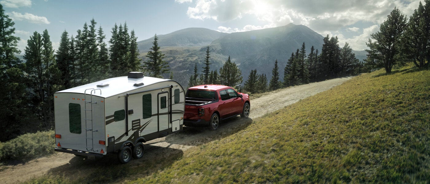2026 Ford Maverick towing a trailer in mountains