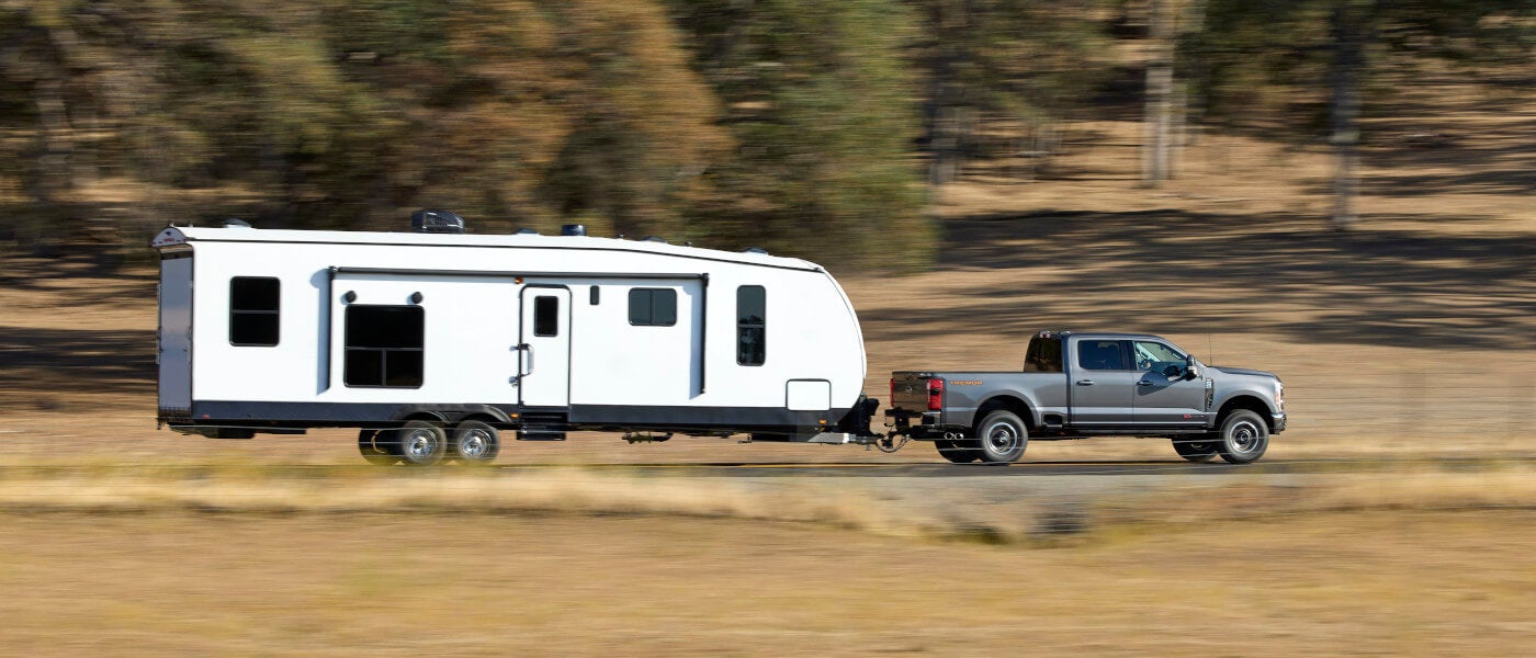 2026 Ford Super Duty side view towing an RV