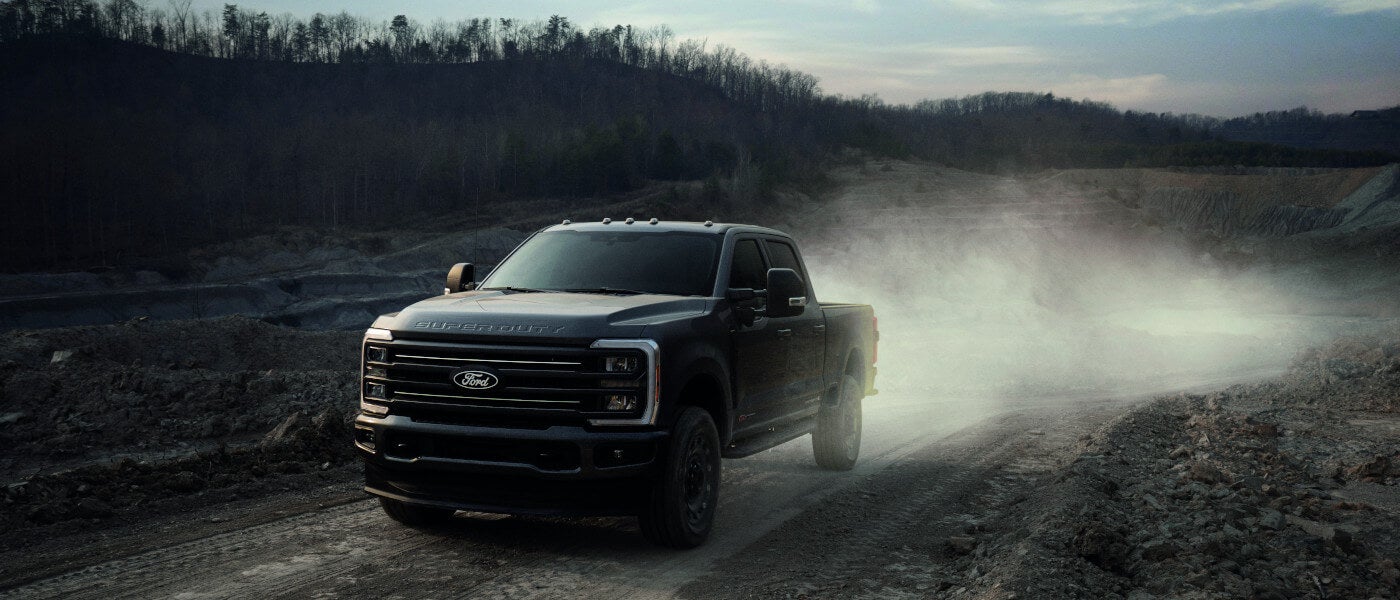 2027 Ford Super Duty kicking up dust on dirt road