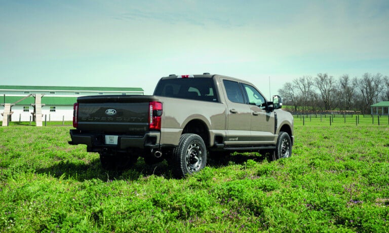 2027 Ford Super Duty facing away in a bright green field