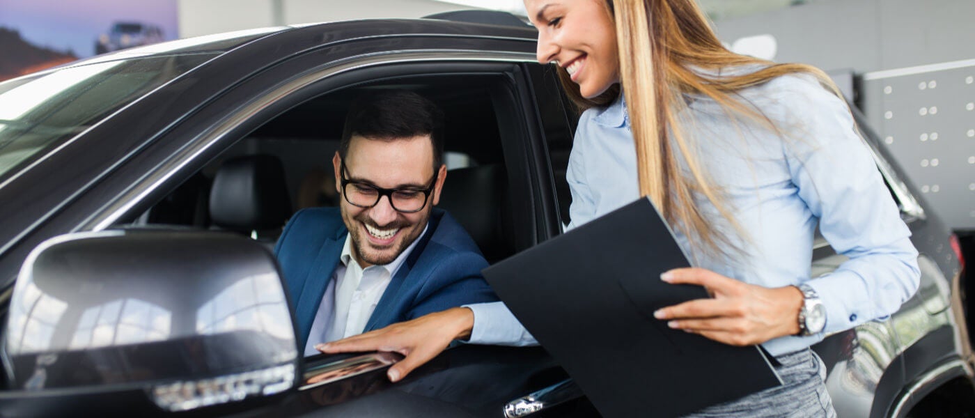 Saleswoman with customer in car