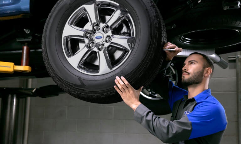 Ford Technician inspecting tire