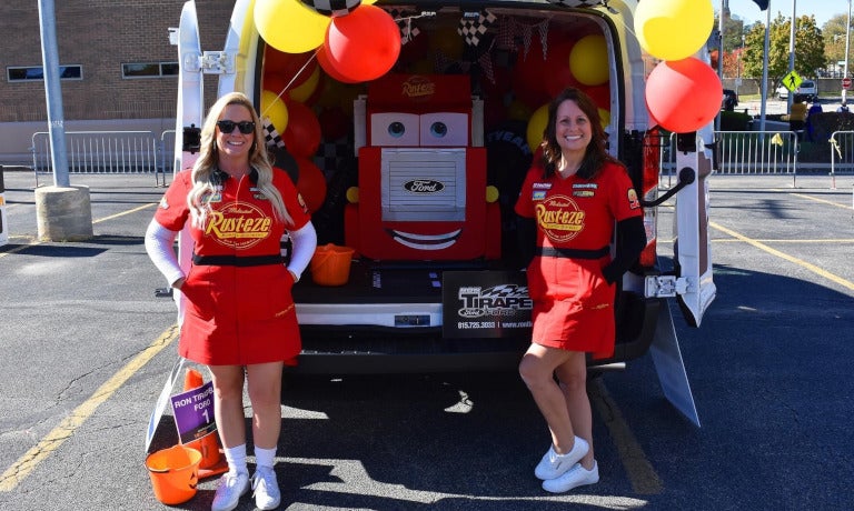 Ron Tirapelli Ford decorated van with team members