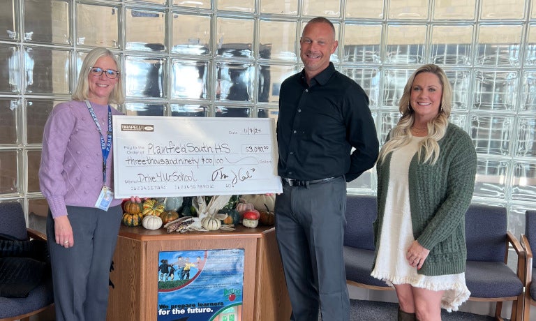 Ron Tirapelli team with giant check